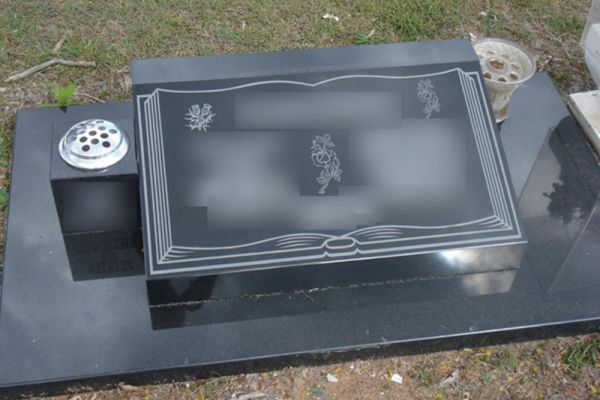 Reclining desk headstone and base with single block vase.