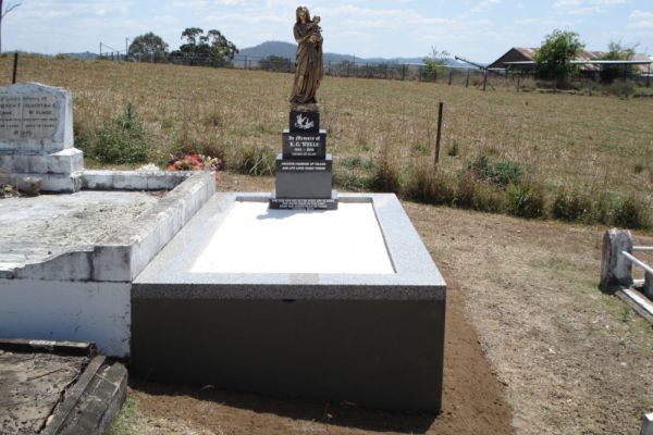 Australian Imperial Black diestones with white incised inscription + bronze statue of Our Lady, Australian Harcourt kerbs, plastered sides, white chips on floor.