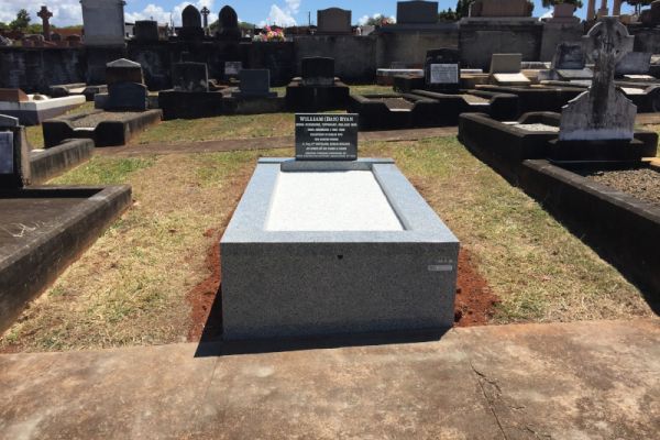 Australian Imperial Black square top headstone, Australian Harcourt kerbs and front veneer, white chips on floor, white incised inscription.
