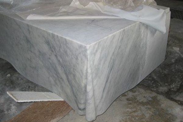 Carving of the Confluenza corner table cloth details.