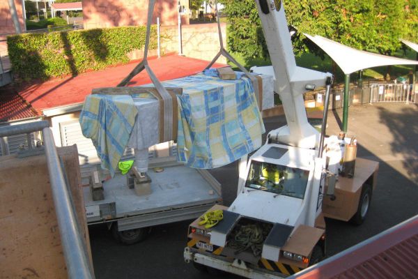 Using a crane to lift the finish piece into position at Roma Street Parklands.
