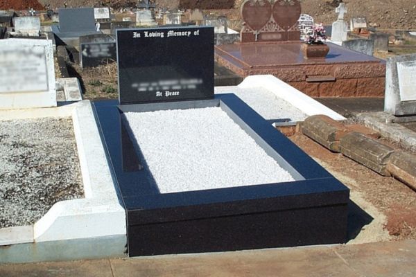 Australian Imperial Black square top headstone, kerbs and front veneer, white chips on floor, white incised inscription.