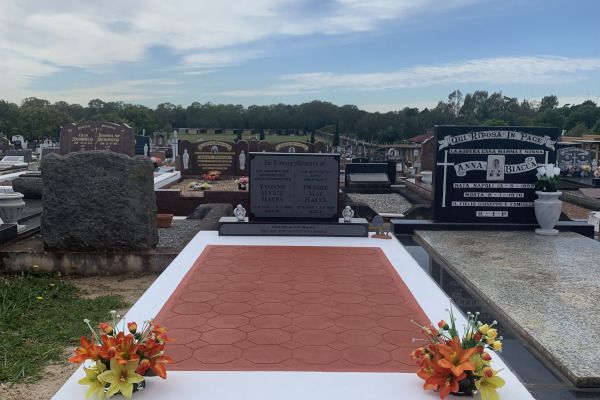 Single monument grave - concrete cover monument with stamped floor and painted in white and terracotta with Australian Imperial Black granite headstone..