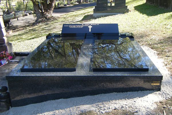 Double Monument Grave with granite cover and reclining desk.
