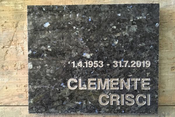 Plaque - Blue Pearl granite with a silver incised inscription.