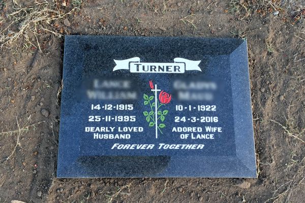 Lawn plaque - Aust. Imperial Black granite with a chamfered edge + white incised inscription  and red and green rose
