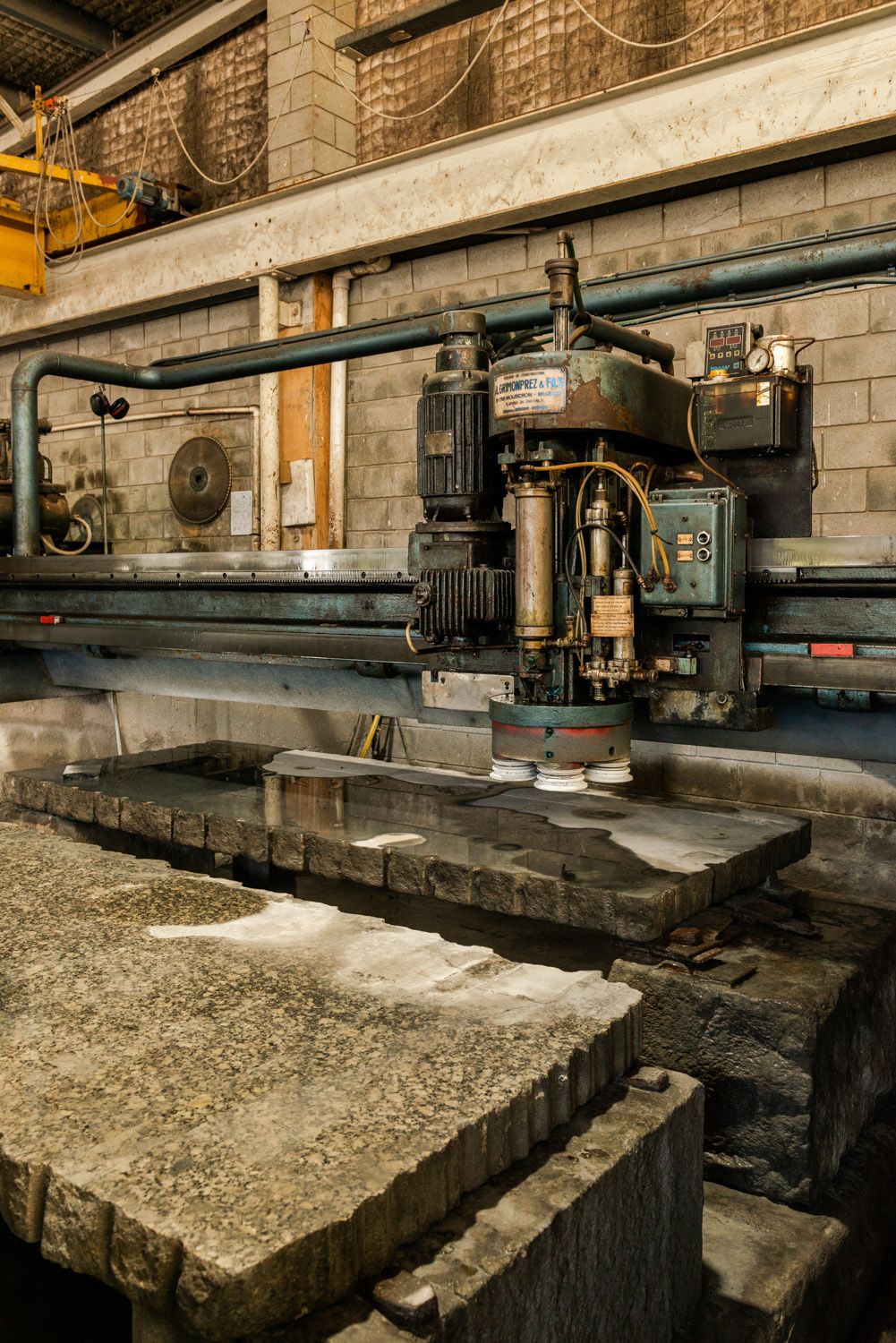 What is a stonemason? Large machinery used to assist preparing the heavy slabs of granite in a stonemason factory.