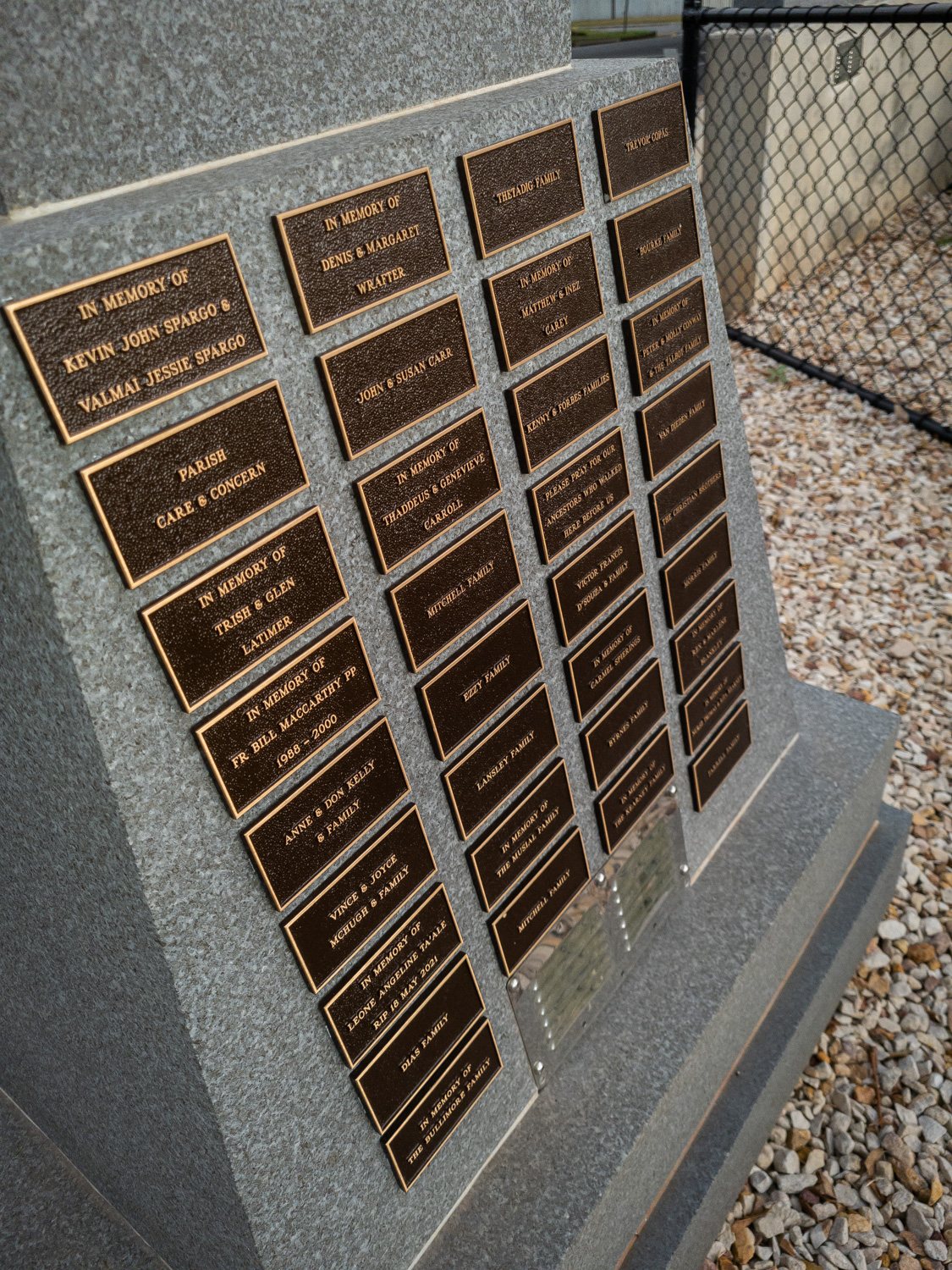 Bronze plaques on granite diestone with names of families who donated funds.