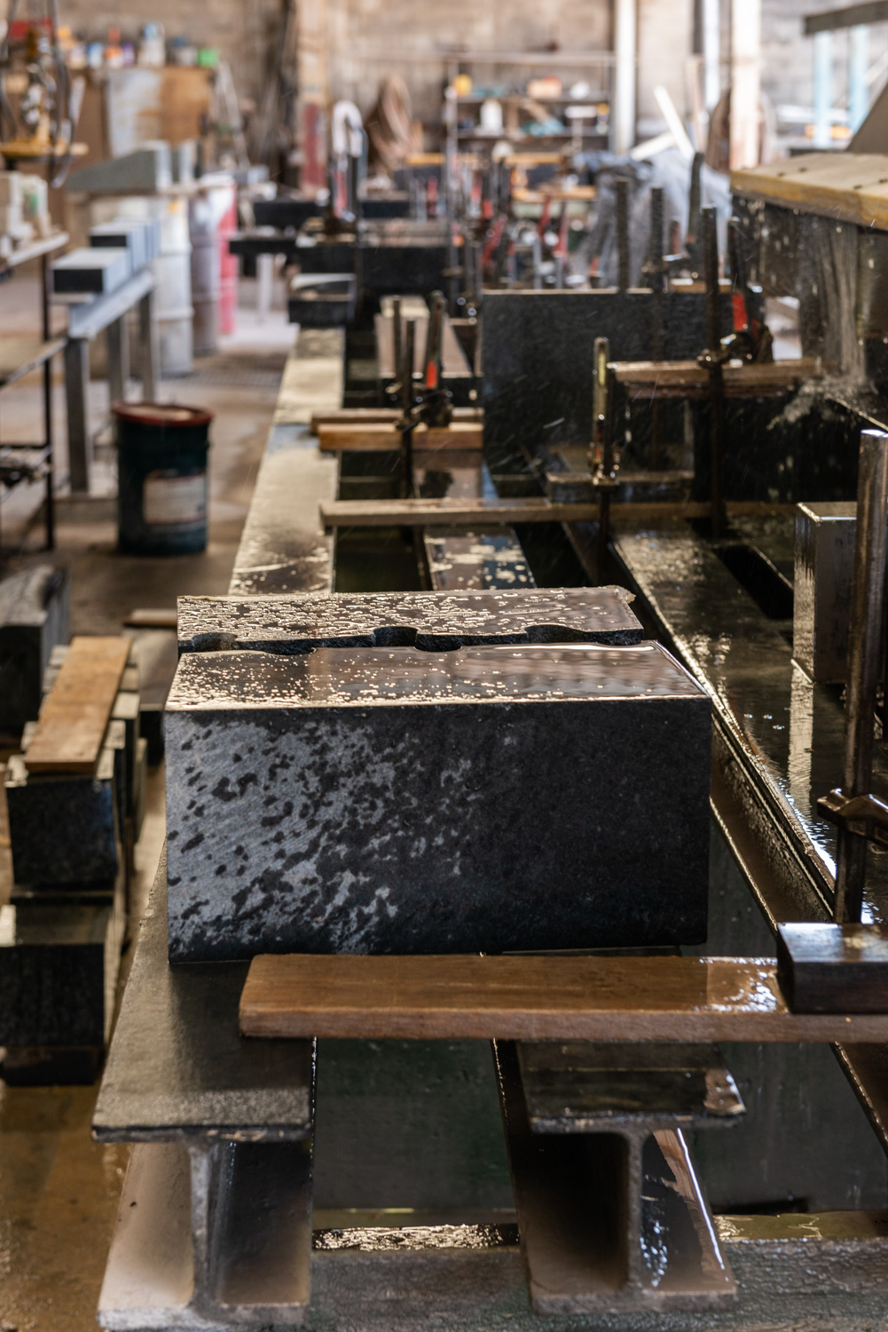 Wetting down natural stone products in our factory to cut and process them.